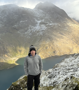 A photo of fundraiser Liam Coombes during another fundraising challenge, a mountain climb.